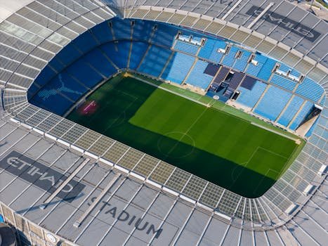 Stunning aerial shot capturing the modern architecture of Etihad Stadium in Manchester.